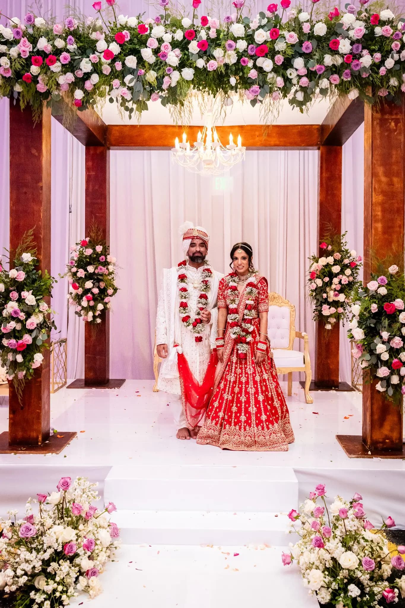Couple beneath a floral mandap at a family destination wedding in Mexico